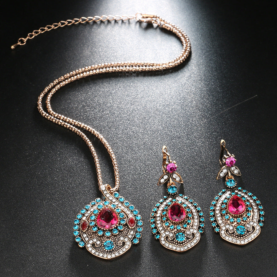 Jewelry set with necklace and earrings on a dark surface