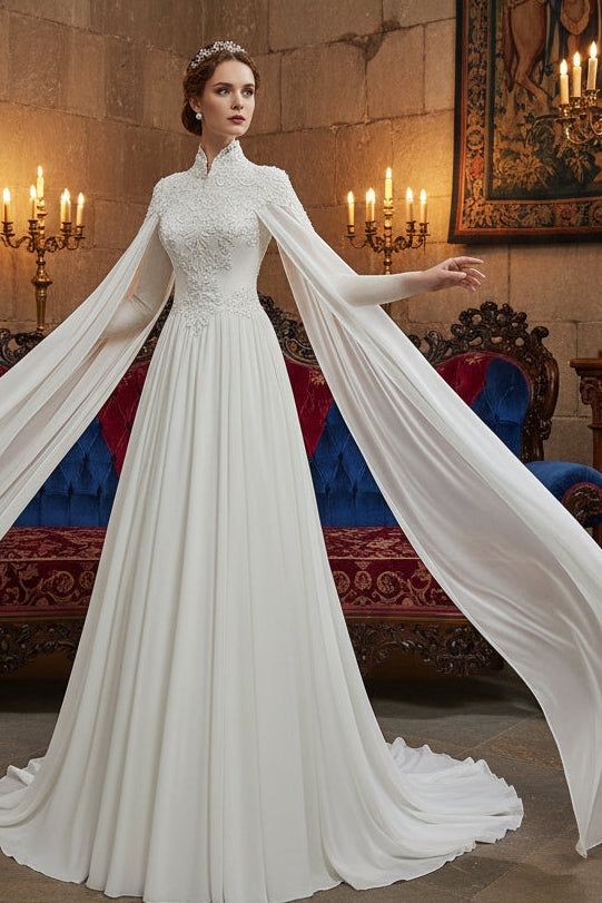 White lace wedding dress with a cape in a room setting