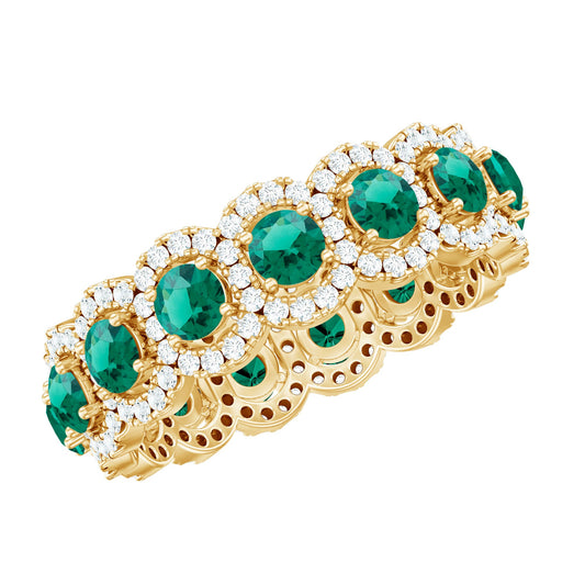 Gold bracelet with emerald and diamond accents on a white background
