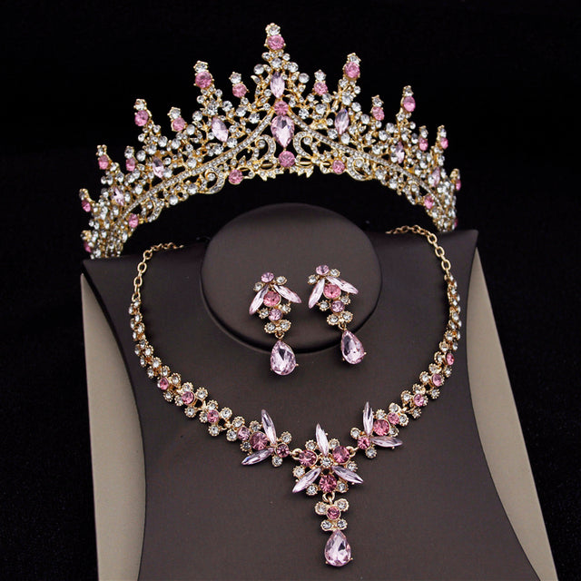 Jewelry set with tiara, necklace, and earrings on a black background