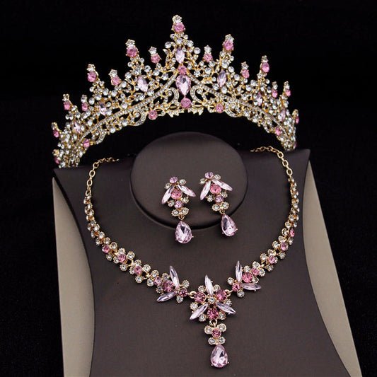 Jewelry set with tiara, necklace, and earrings on a black background