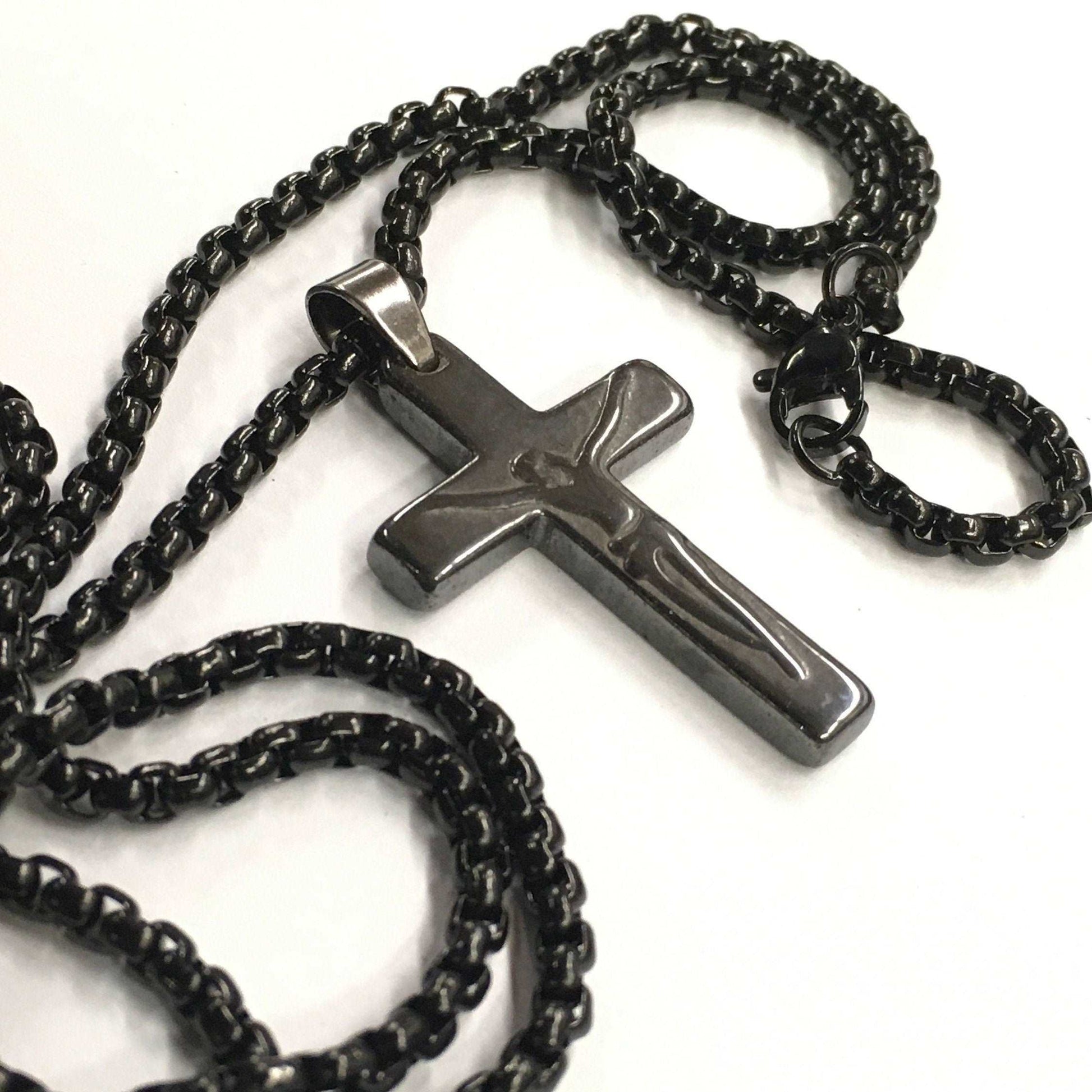 Black chain necklace with a cross pendant on a white background